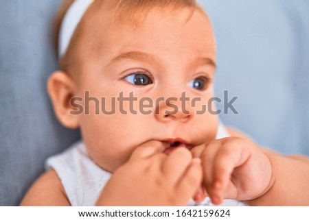 Adorable baby lying down on the sofa at home. Newborn relaxing and resting comfortable