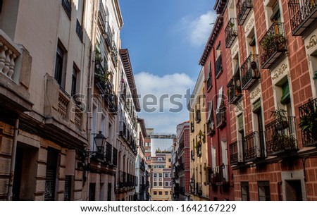 Exterior view of beautiful historical buildings in Central Madrid, Spain, Europe. Colorful street scene in the Letras neighborhood of the Spanish capital. Facade of traditional heritage buildings. Royalty-Free Stock Photo #1642167229