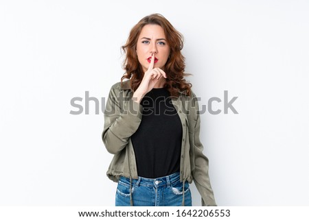 Young Russian woman over isolated white background showing a sign of silence gesture putting finger in mouth