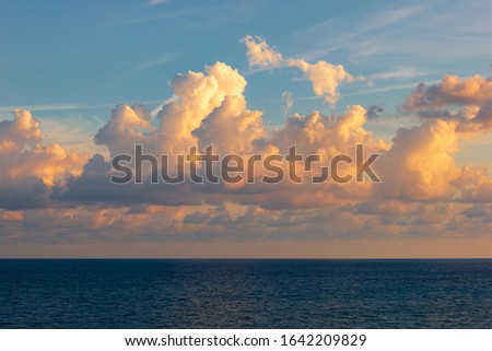 View of the sun setting over the horizon of the sea, ocean. Beautiful sunset sea. Sea sunset background.
