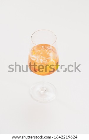 clear alcohol drink in wineglass with lemon peel decoration
