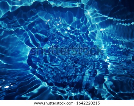Art of​ reflection​on​ on​ surface​ blue​ water​ for​ background. Abstract​ of surface​ blue​ water​ for​ background​