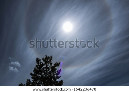 Cirrostratus clouds and solar halo  Royalty-Free Stock Photo #1642236478