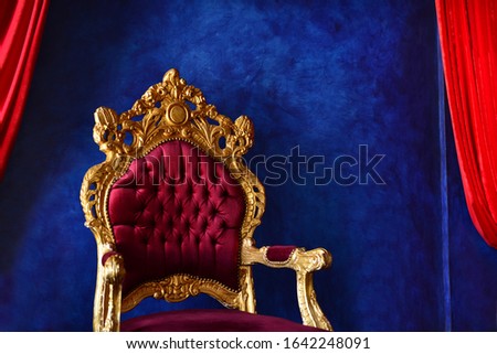 Luxury classical interior with blue wall and purple-golden chair. Extraordinary Blue And Purple Interior. Blue and red contrast with walls.Expensive home interior with violet armchair. Royalty-Free Stock Photo #1642248091