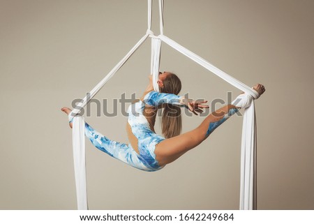 girl on the air silk gymnastics silhouette isolated on the white background