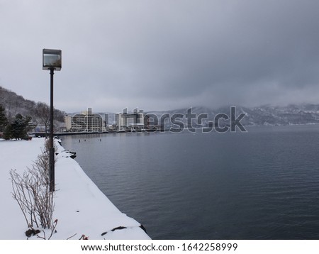 Winter picture of white covered water side area in middle of March, Toya Lake, Hokkaido, Japan