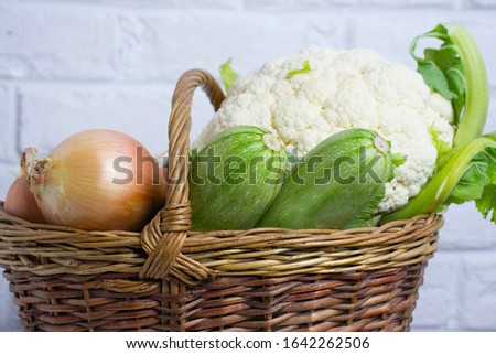 Different vegetables in basket isolated on white
