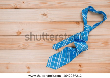 color male tie on a wooden table. shopping concept