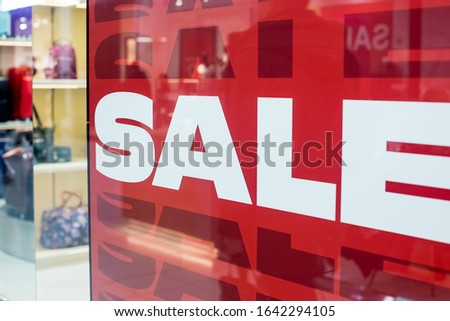sales promotion of fashion retail store in shopping mall. store front display for fashion background.Season sale, black friday and shopping concept. Red stand SALE percent discount price in shop