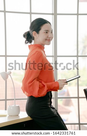 Shot of a young businesswoman using a digital tablet in a modern office
