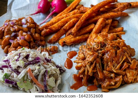 Vegan jackfruit bbq with baked sweet potato fries.