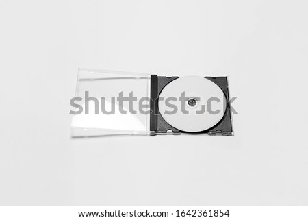 Open compact plastic disc box case with white isolated blank for branding design. CD jewel mock-up on soft gray background.High resolution photo.