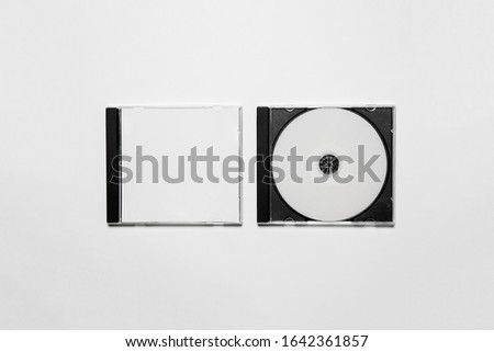 Closed compact plastic Disc Box Case with white isolated blank for branding design. CD jewel mock-up on soft gray background  Royalty-Free Stock Photo #1642361857