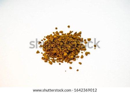 Pile of ground coffee powder or instant coffee grain isolated on a white background. Shot of top view on brown granules.