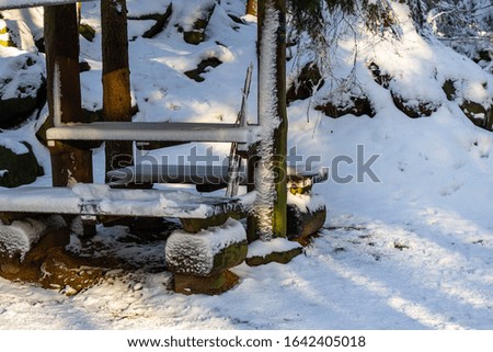 Wooden bench in the winter forest. Mountain Zlatar in Serbia, Europe.