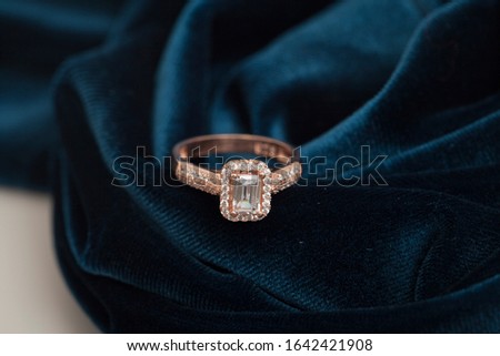 photo of sparkly lady's ring on velvet fabric