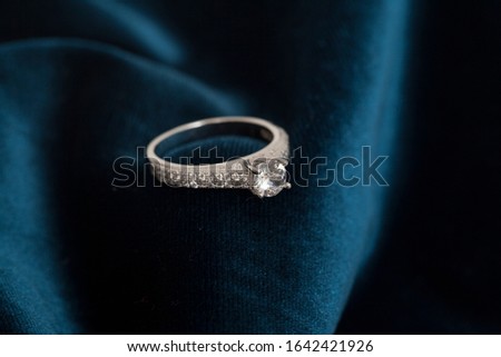 photo of sparkly lady's ring on velvet fabric