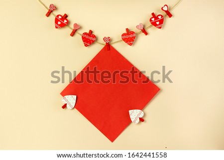 greeting card on clothespins in the shape of a heart with place for text, holiday concept