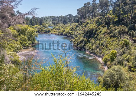 Calm and idyllic part of Waikato River near Huka Falls, New Zealand. Royalty free stock photo.