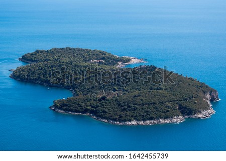 Lokrum island near Dubrovnik, Croatia, covered by trees in summer. Royalty free stock photo.