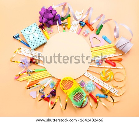 Colorful celebration background with various party confetti, balloons, streamers, gifts and decoration on color background.