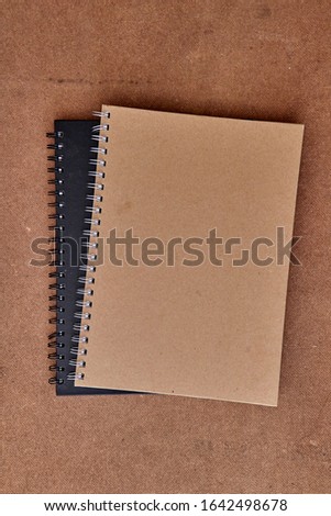 A studio photo of an office note book