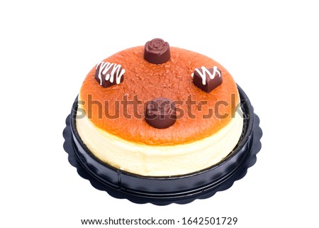A picture of cheesecake with special made valentines chocolate on top for decoration.