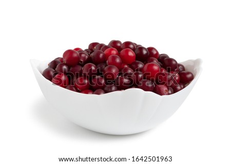 Ripe cranberries in a white ceramic bowl isolated on white background