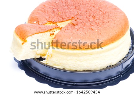 A picture of moist cheesecake slice, left and lift on the plate.