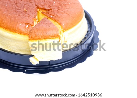 A picture of moist cheesecake slice, left and lift on the plate.