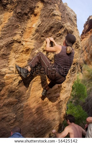 Young men are doing bouldering - sunset light. Shot in Gifberg Mountains, near Wanrhynsdorp, Western Cape, South Africa.