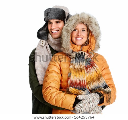 Happy couple in winter clothing isolated over white background.