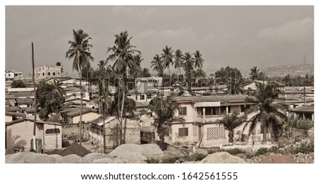 Retro photo. Vintage. African town. Old postcard. Top view on residential district, densely located houses, yards and palm trees. Matte background.