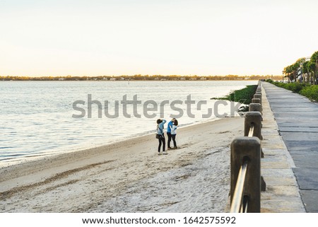 A Photographer Works Shoots a Romantic Couples Session on the Beach