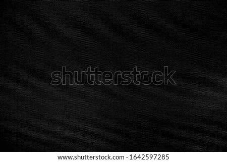 The texture of the dark black canvas for the background design image