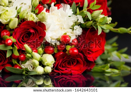 Wedding bouquet with bright red and white roses. Bridal accessories