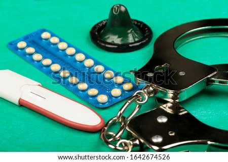 Contraceptive pill , condom, handcuffs and pregnancy tests for prevent pregnancy
