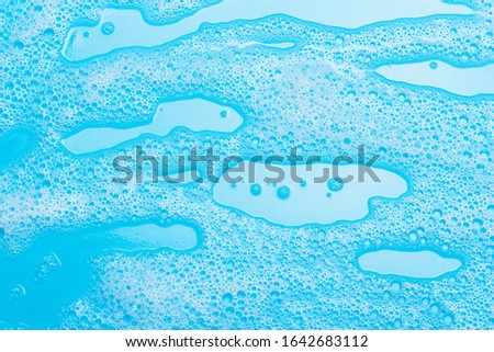 detergent foam, shampoo, soap bubbles on blue background. The concept of cleanliness, cleaning