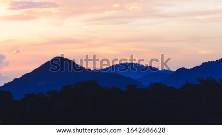 silhouette black and blue mountain with attractive background, sunset pastel-tone sky, in panorama