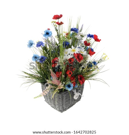 A large wicker basket with wildflowers.