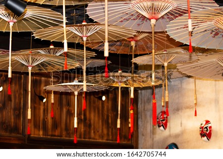 Chinese traditional flower paper umbrella and Peking Opera facial makeup in the house Royalty-Free Stock Photo #1642705744