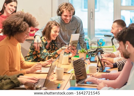 Young teamwork using computer in the apartment. Millennial people working together at new project. Youngers looking cute videos. Technology, influencer, marketing and job concept - Image