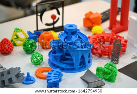 Models printed by 3d printer. Copy space. Bright colorful objects printed on a 3d printer on a table. Modern additive technologies 4.0 industrial revolution