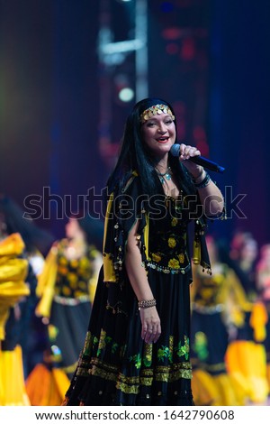 Show team of musicians, singers and dancers in gypsy costumes singing and dancing on stage