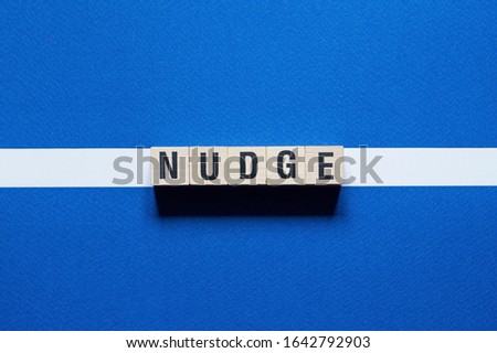 Nudge word concept on cubes Royalty-Free Stock Photo #1642792903