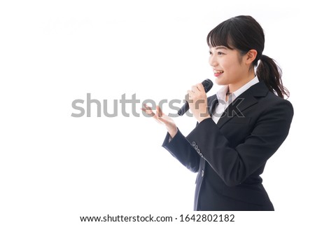Young business woman speaking on mic