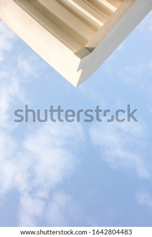 The corner of the white building and the clear sky