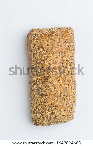 Bun of rye bread with various seeds on the top