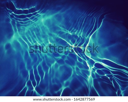 The​ pattern​ of​  ​ texture​ on​ surface​ blue​ water​ in​ the​ deep​ sea​ for​ background​