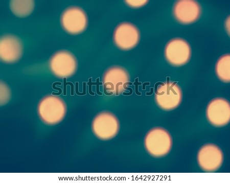 blurred bokeh background from neon rays in yellow light on a blue background                   